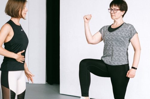 Two women working out together, demonstrating fitness exercises on a white background.